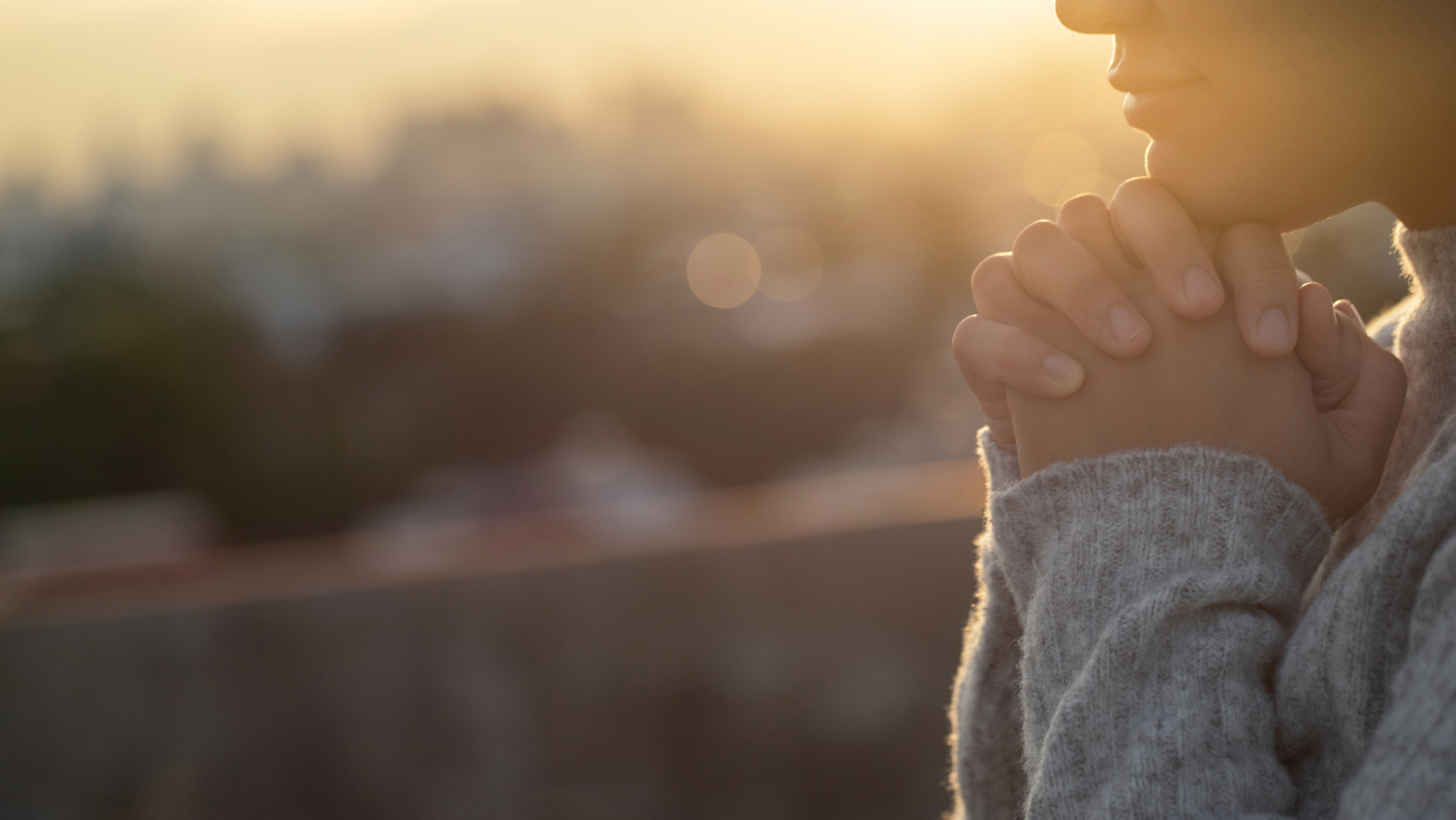 Women raise their hands to ask for blessing from God.